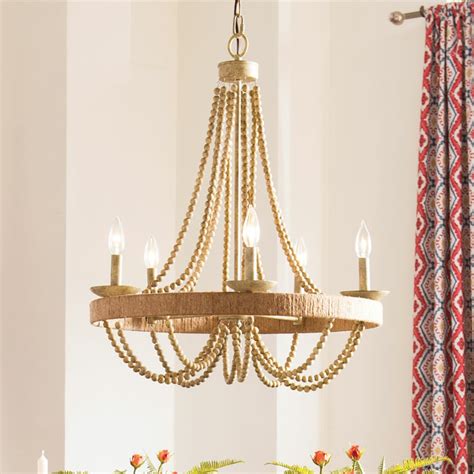 It's designed with wooden beads and strands of crystals hanging down from the top that adds a perfect touch of farmhouse charm. . Birch lane lighting